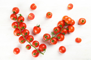 Naklejka na ściany i meble Branch of juicy organic red cherry tomatoes arranged in row on isolated white background. Polished vegetables. Clean eating concept. Vegetarian diet. Copy space, flat lay, top view.
