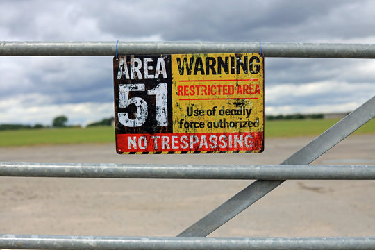 Vintage Area 51 Warning Sign Hanging On A Gate. Extraterrestrial Storage Facility Concept.
