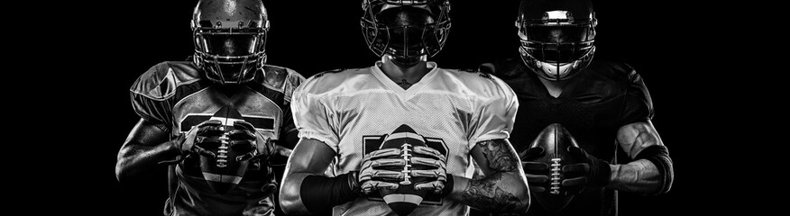 American football player, sportsman in helmet on dark background. Black and white photo. Sport...