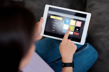 Human pointing at icon on touchpad display while choosing something to watch