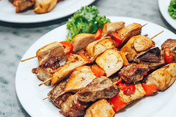 assorted chicken and beef skewers on a wooden stick.