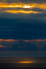 Fototapeta na wymiar Sunset in the clouds over the ocean.