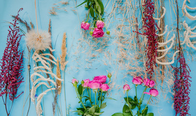 Floral pattern with wildflowers on blue background.