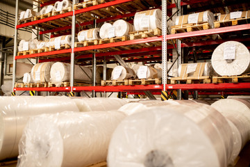 Rows of rolled and packed newly produced huge bobbins of polyethylene membrane
