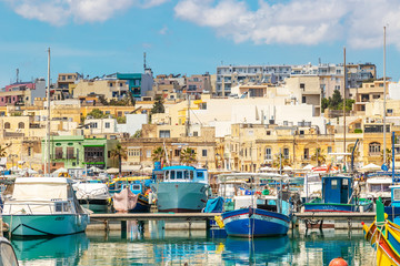 The traditional eyed boats in the harbor of fishing village Marsaxlokk in Malta