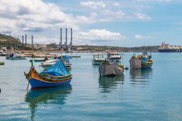 The traditional eyed boats in the harbor of fishing village Marsaxlokk in Malta