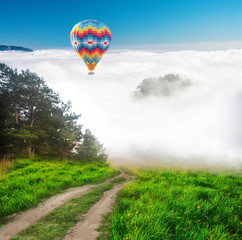 Hot air balloon floating over clouds