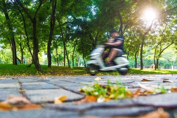 trip on electric scooter in park in motion