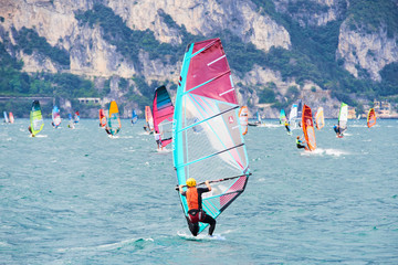  Water sports on Lake Garda in Torbole resort. Windsurfer Surfing The Wind On Waves, Recreational...