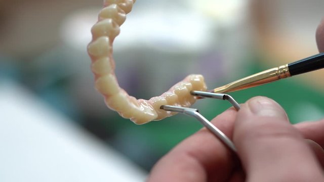 Zirconium Denture Polishing and Shining in Dental Laboratory, Close Up