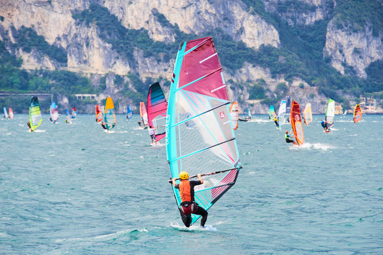  Water sports on Lake Garda in Torbole resort. Windsurfer Surfing The Wind On Waves, Recreational Water Sports, Selective focus