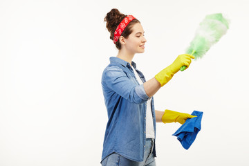 Pretty woman in work-wear uses dust cleaning supplies not facing the camera.