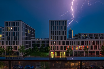 A lightning crashes into an office building at night.