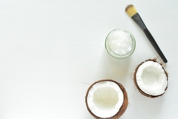 Coconut oil for cosmetic in glass jar, minimal composition on white background.