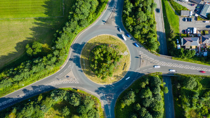 Aerial long exposure of traffic on a roundabout in a small town