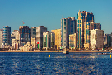 Sharjah skyline with mosque at sunny day, United Arab Emirates