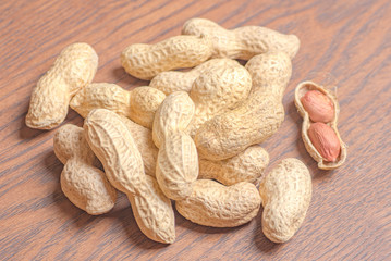Close up to peanuts on wooden background. peanuts texture