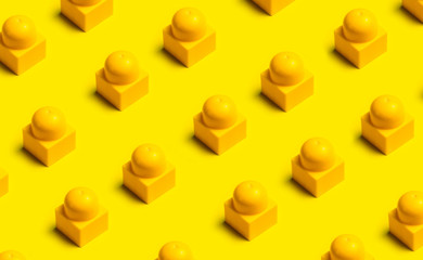 Fototapeta na wymiar Top view of plastic blocks background. Flat lay image of toy background made with yellow building blocks from child constructor. Bright yellow plastic building blocks on yellow background.