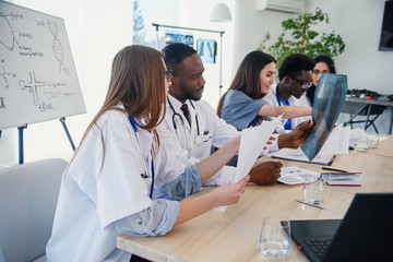 Team of professional doctors having a meeting in conference room at the modern hospital. Health care and medical developmant concept.