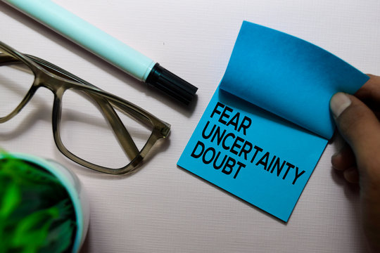 Fear Uncertainty Doubt (FUD) text on sticky notes isolated on office desk