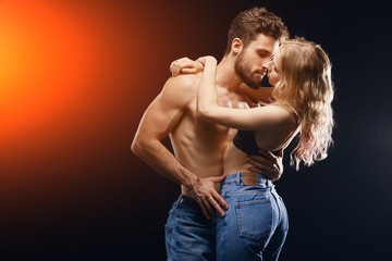 couple in jeans in the privacy. close up portrait. isolated black background. copy space