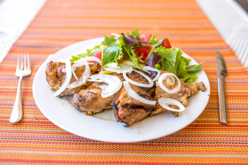 Healthy meal, plate full of chicken meat and fresh salad with tomato, paprika, onions and arugula