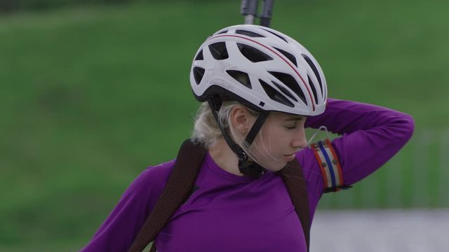 Portrait of Caucasian female professional biathlete practicing on a shooting range during mid-season practice in summer. ARRI Alexa Mini with Cooke S4 prime lenses RAW graded footage