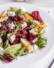 Fresh mixed salad in a bowl on a white background