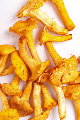 Raw fresh chanterelle mushrooms on a white background. Top view