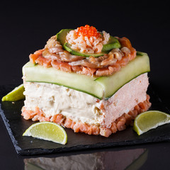 Piece of traditional savory swedish sandwich cake Smorgastorta