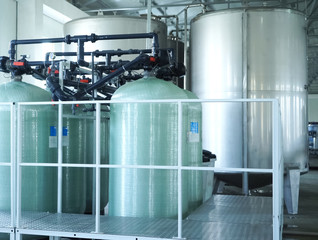 Filling line of sparkling water in pet bottle. Mini factory for bottling water.