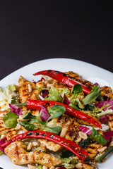 Mexican salad with hot pepper chiken fillet lettuce on plate