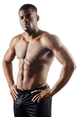 Fototapeta na wymiar strong afro-american handsome guy showing off his physique against white background.close up portrait. isolated white background. studio shot.