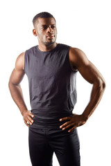 confident handsome young african man standing with hands on the hips , looking away against white background. close up portrait. free time, spare time, man has a rest after workout. fashion