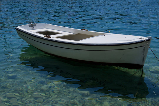 White rowing boat on the water