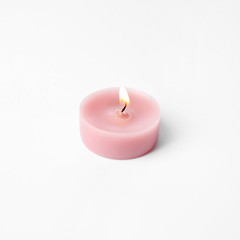 Pink wax decorative candle isolated on white