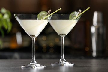 Glasses of tasty cucumber martini on bar counter