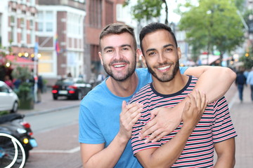 Proud interracial homosexual couple outdoors