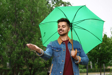 Man with umbrella outdoors on rainy day