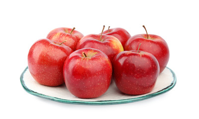 Plate of ripe juicy red apples on white background