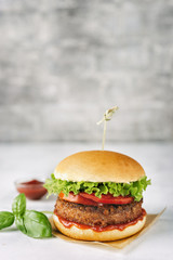 Homemade vegan burger on white rustic background