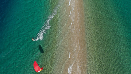 Aerial drone photo of kite surfer practising in tropical exotic sandbar part of island Atoll with turquoise and emerald open ocean sea