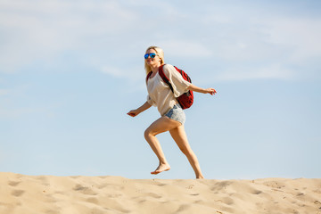Adult woman hiking and backpacking in beautiful desert and rocky landscape