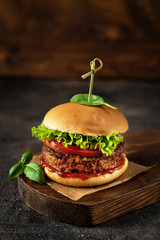 Vegan burger on dark rustic brown background
