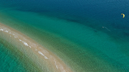 Aerial drone photo of kite surfer practising in tropical exotic sandbar part of island Atoll with...