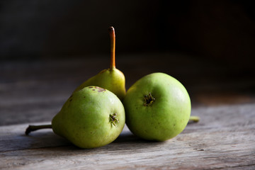 Pears lie on old oak boards.