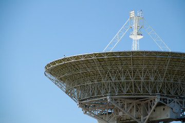 white radio telescope against the sky