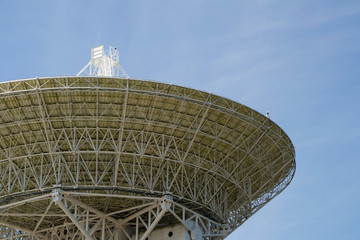 white radio telescope against the sky
