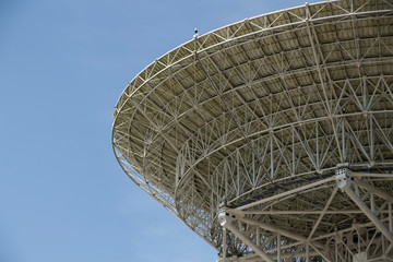 white radio telescope against the sky