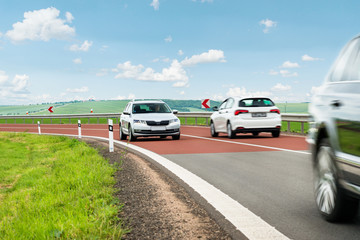Obraz na płótnie Canvas Countryside road and cars in motion